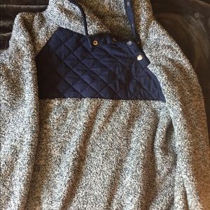 A light blue ,white and navy blue pull over